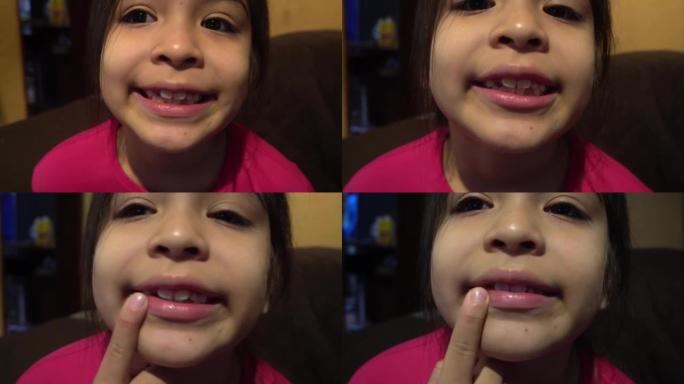 一个白人小女孩在4k的早晨在室内展示她刚掉下来的牙齿，黑色的头发和淡紫色的polo衫