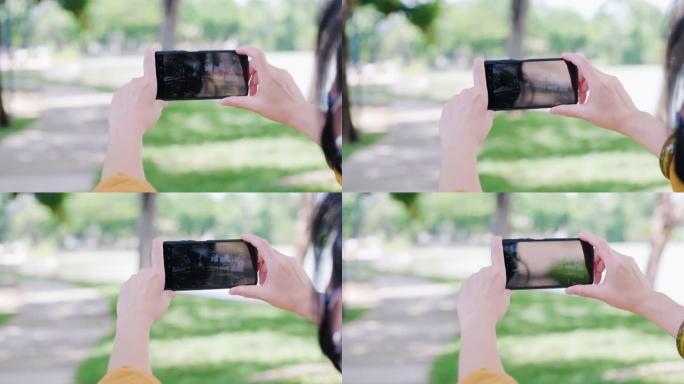 女人使用手机和增强现实应用程序在公园预报天气