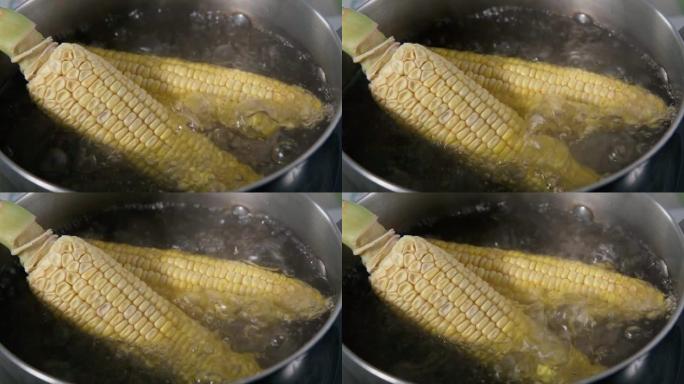 用沸水煮玉米特写。慢动作