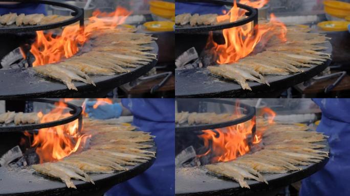 慢动作: 在美食节上用黑色烹饪欧洲臭鱼的过程