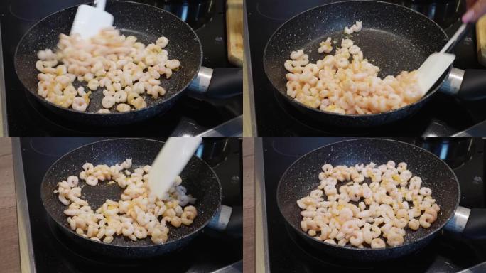 在煎锅中烤去皮虾的过程，特写镜头。虾油炸。自制海鲜