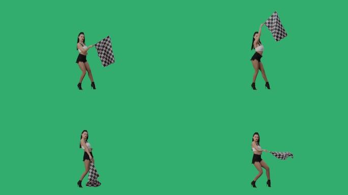 性感的黑发女人挥舞着黑白方格赛旗，标志着比赛开始。年轻女子在绿屏背景下摆出全长姿势。慢动作就绪，4k