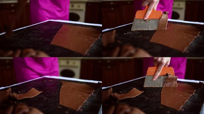 顶部视频显示了一个巧克力女人在大理石桌子上搅拌回火的液体黑巧克力，用蛋糕刮刀将其冷却并准备美味的巧克