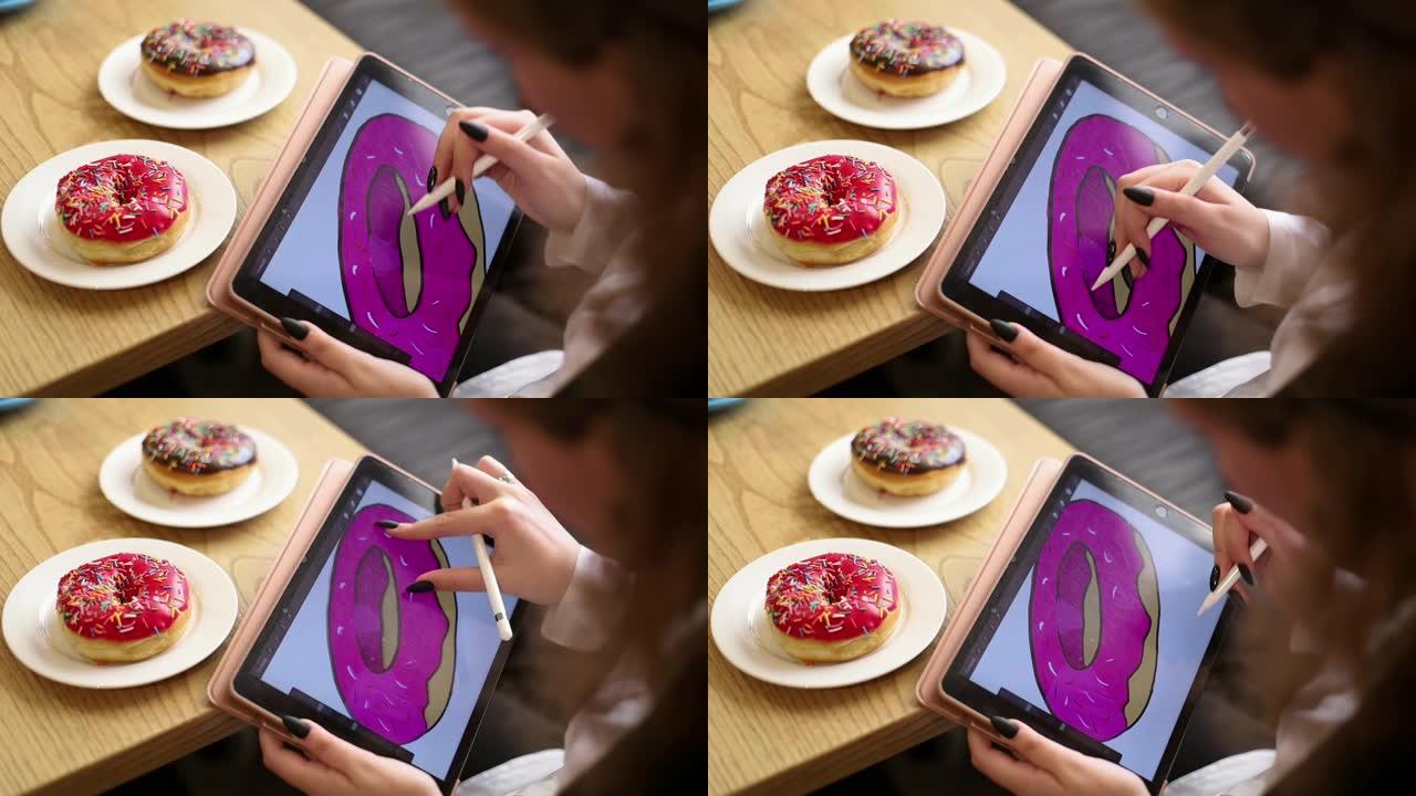 女人的手在电子平板上画一个甜甜圈。
