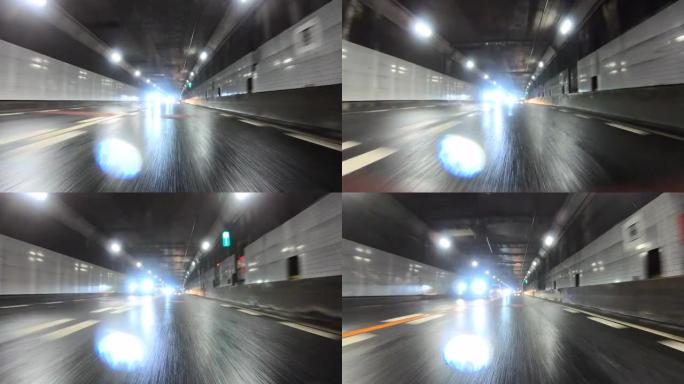 雨天开车穿过高速公路隧道。向后看