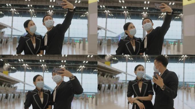 两名年轻的中国空姐戴着防护面罩，在前往下一个目的地前一起自拍——库存视频
