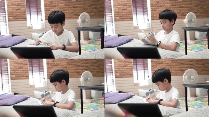 亚洲男孩在家参加在线课程。