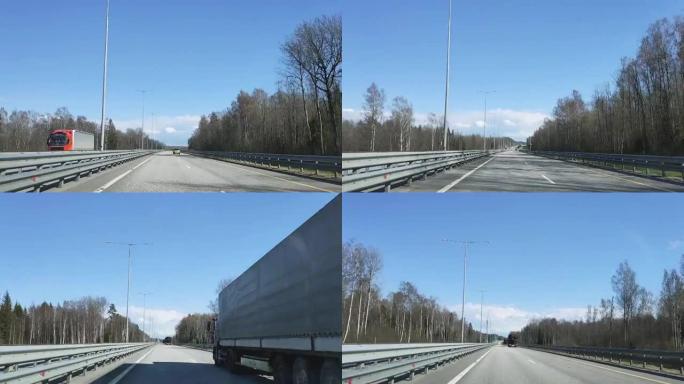 时间圈。在阳光明媚的天气中，通过在圣彼得堡莫斯科高速公路上行驶的汽车的挡风玻璃观看