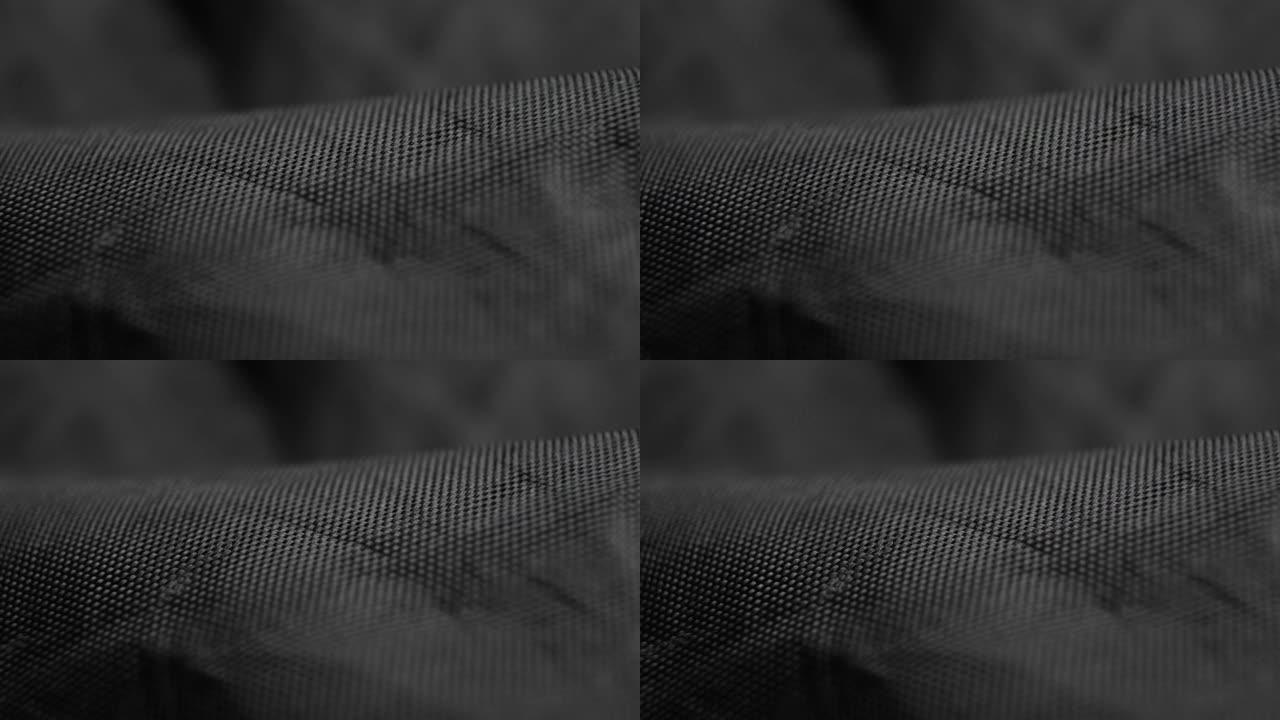 波浪形黑色合成织物。纹理折痕