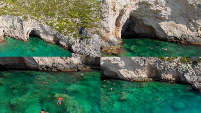 在希腊扎金索斯岛游泳的游泳者的4k视频无人机视图