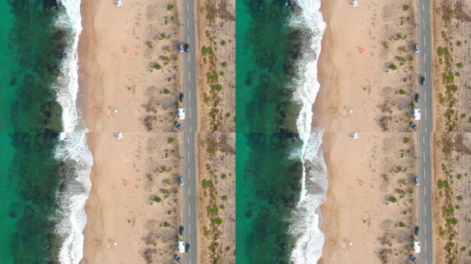 4k视频无人机视图汽车在海滩附近的道路上行驶