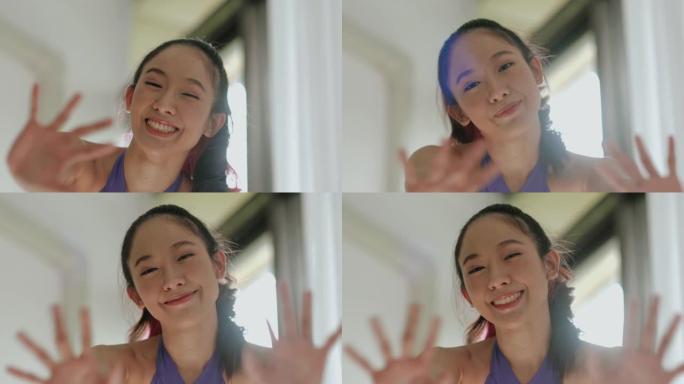在开始锻炼前，关闭年轻的亚洲活跃女性微笑并向相机问好-股票视频