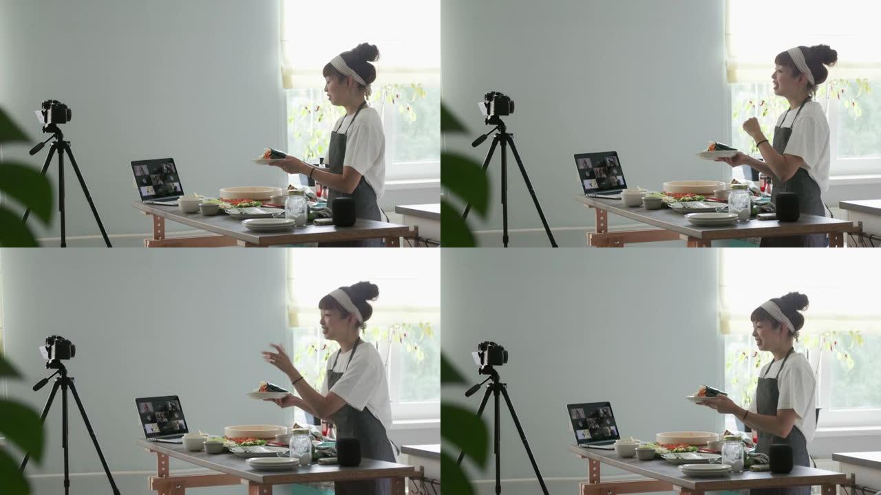 日本女性影响者和厨师向她的虚拟烹饪班观众展示temaki寿司卷