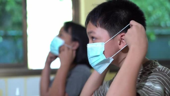亚洲学生正在学习如何正确戴口罩。教育中的防疫理念