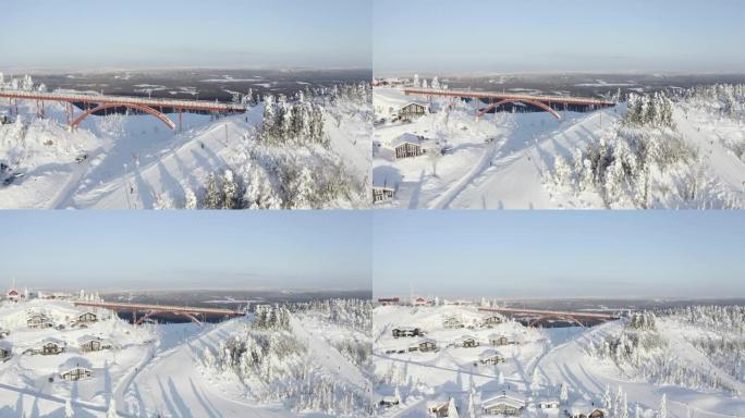 在瑞典寒冷的冬天，无人机拍摄了一座桥和一个小村庄。