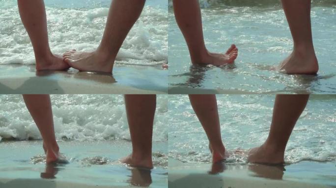浪漫情侣双脚触摸热带沙滩的特写镜头。度假，热带蜜月概念。浪漫情侣双脚触摸热带沙滩的特写镜头。度假，热