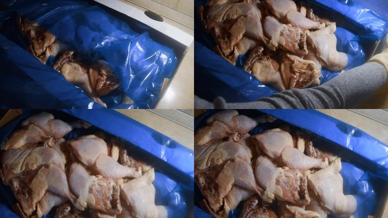 双手戴着手套打开装满冷冻鸡腿的盒子的俯视图。用冰覆盖的冷冻生鸡肉。4k视频