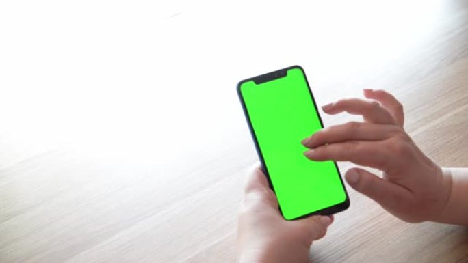 手机手色度键绿屏模型，用于观看内容特写。向左滑动并单击中心以进行商店的网上冲浪。垂直智能手机显示屏