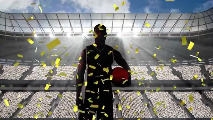 金色五彩纸屑落在男子篮球运动员对体育馆持球的剪影上