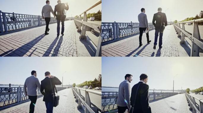 两名商人在远离相机的桥上走过桥，缓慢放大，直到相机与他们水平