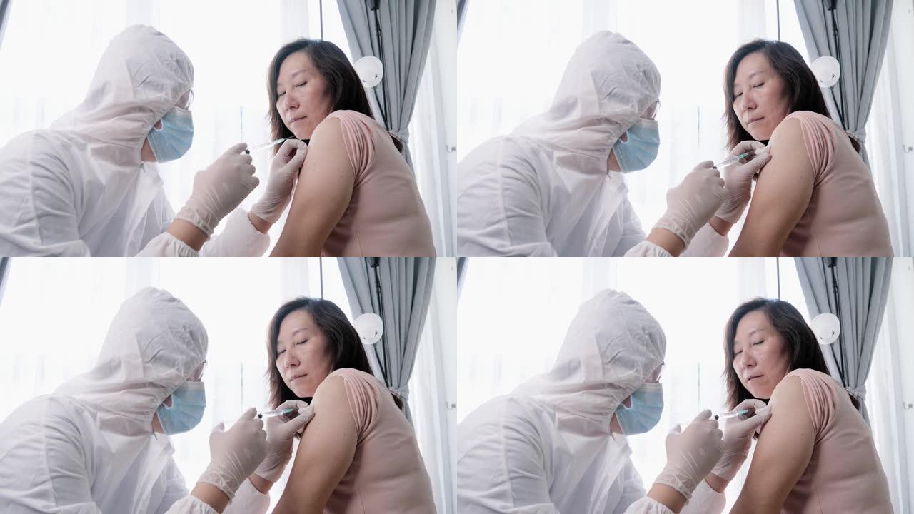 实验室工作人员在新型冠状病毒肺炎爆发期间向亚洲妇女注射电晕病毒疫苗