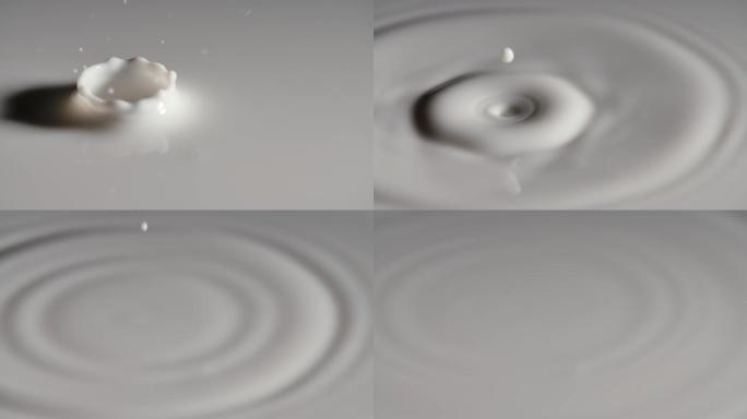 一滴牛奶落在白色液体的表面，产生波纹波，形成美丽的皇冠飞溅。滴滴牛奶有波纹和圆圈，慢动作。特写