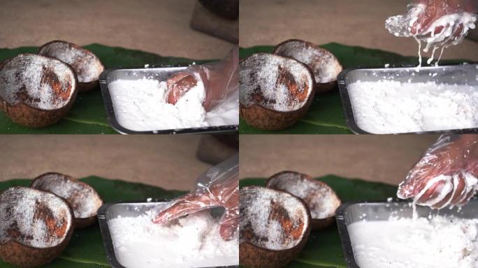 椰子按摩用于椰奶生产泰国传统椰奶生产，椰奶，用于制作对泰国人重要的食物和甜点的天然成分。