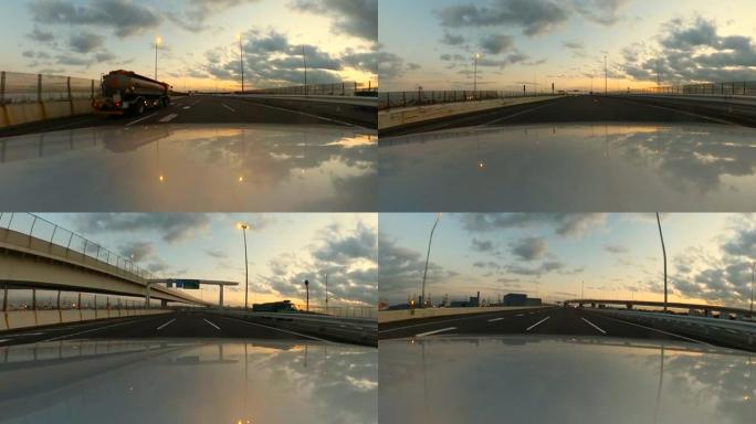 黄昏时在高速公路上开车。汽车引擎盖上的摄像头。动作相机拍摄。
