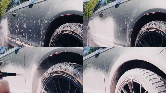 洗车和汽车细节服务，使用高压清洗机用泡沫覆盖汽车，特写视频