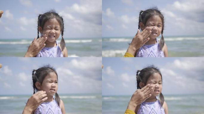 快乐的小女孩暑假站在热带海滩上防晒紫外线
