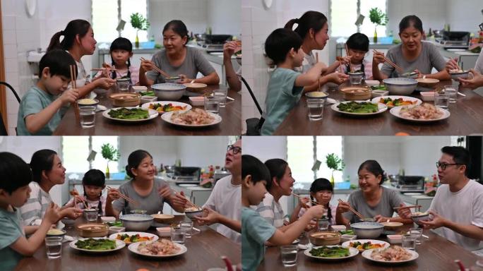 快乐的亚洲华人家庭在家里吃午饭
