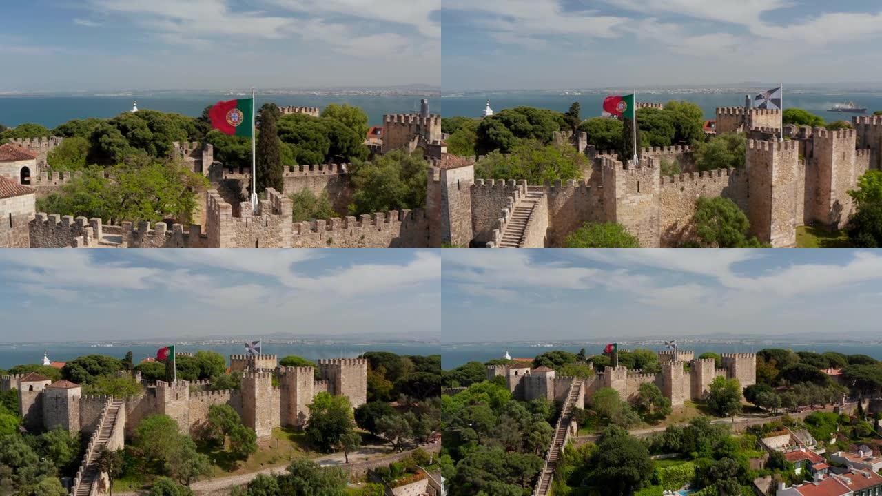 中世纪圣乔治城堡上方的波兰人上的国家和市政旗帜的特写镜头。无人机摄像机向后飞离地标。葡萄牙首都里斯本
