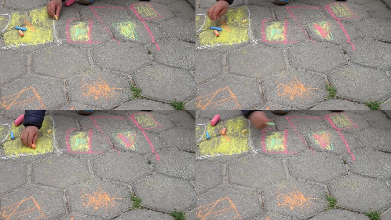 儿童在瓷砖人行道上用彩色蜡笔画画