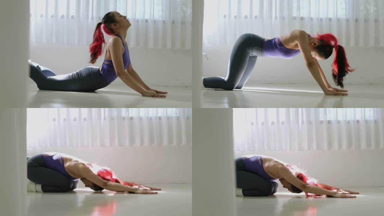 泰国体操女子弯腰，抬头看，膝盖在地板上，弯下腰，伸手到前面伸展-股票视频