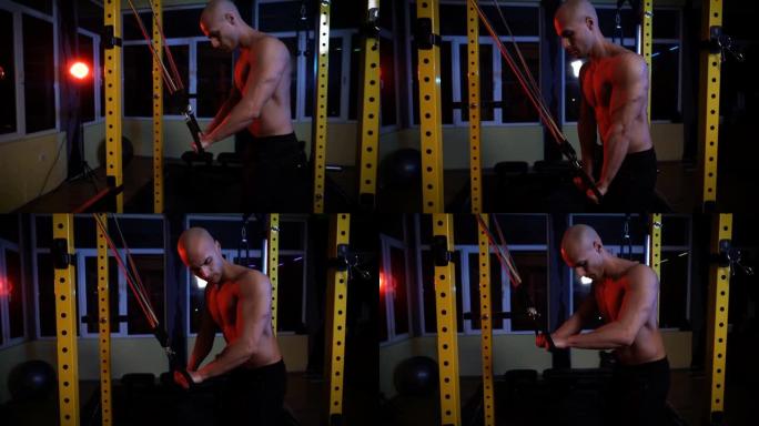 肌肉发达的男性健美运动员在肱三头肌上进行重物训练