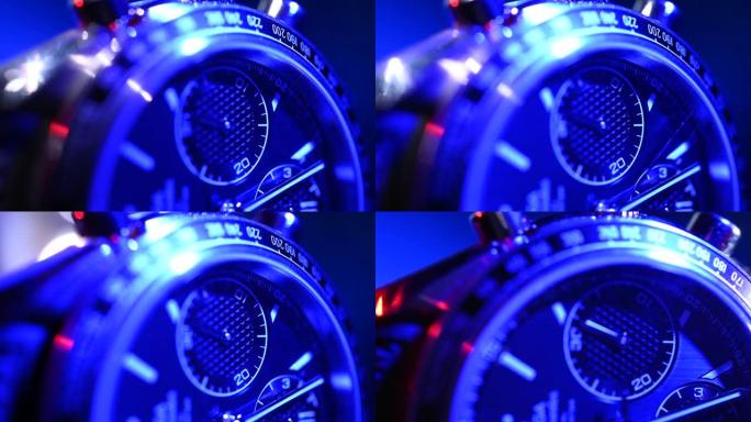 红色和蓝色灯光的现代豪华钟表特写。计时手表