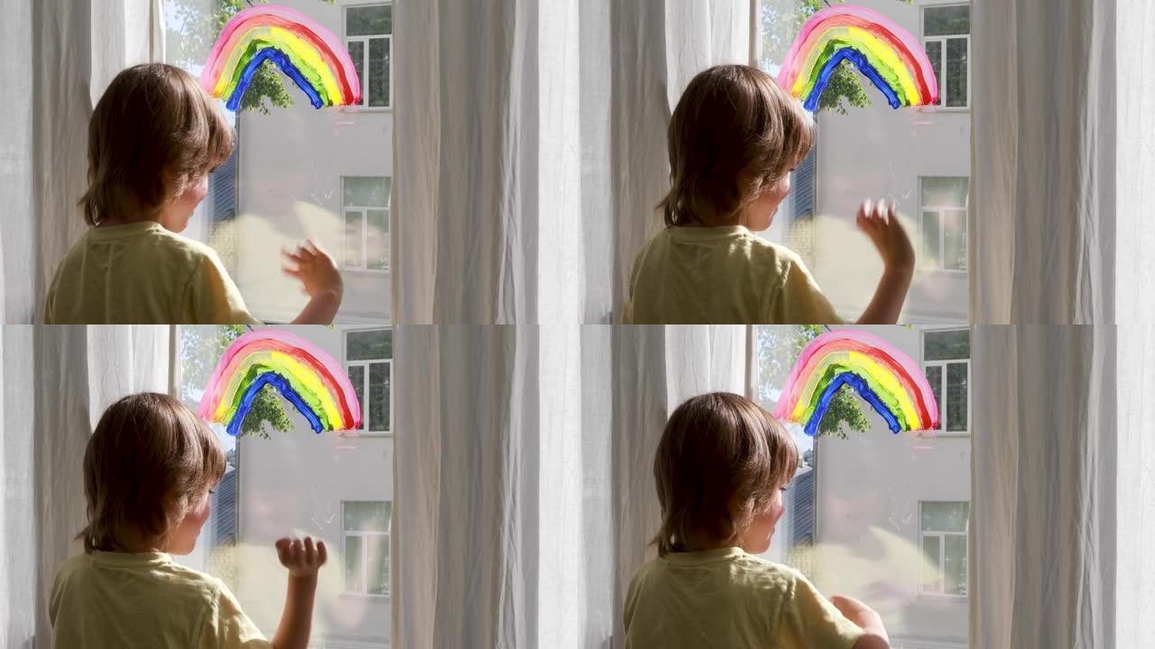 学龄前儿童男孩站在窗户附近，有五颜六色的彩虹