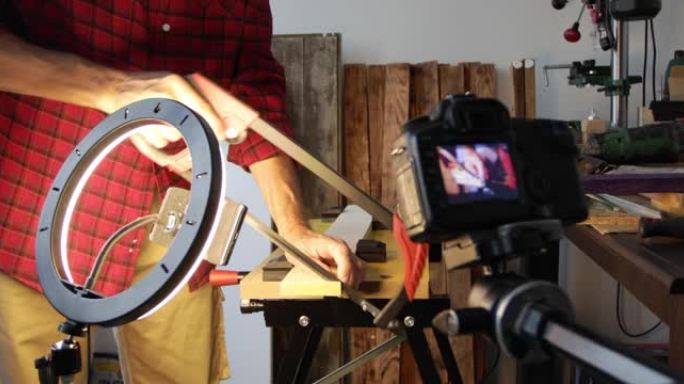 DIY木工博客，男人用手锯切割木板，拍摄