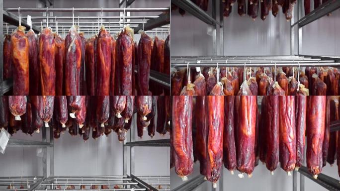 腌制的肉挂在肉类加工厂的架子上。传统食品。烟熏香肠肉挂。高质量全高清镜头