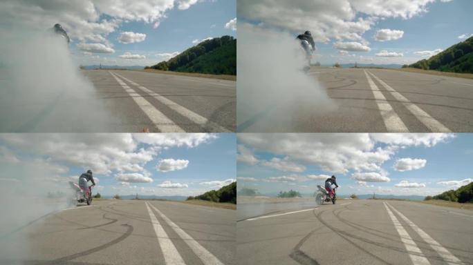 狂野的极端摩托车手在摩托车上做轮胎烧毁，慢动作