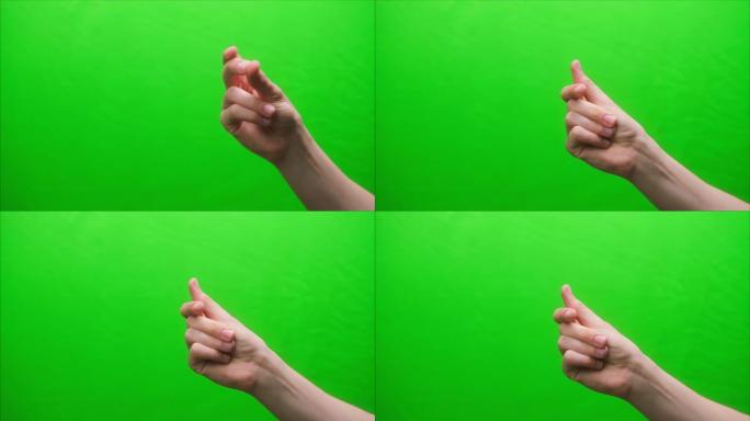 绿色背景上的手势特写，用手指点击，在工作室里打手势，节奏声音概念