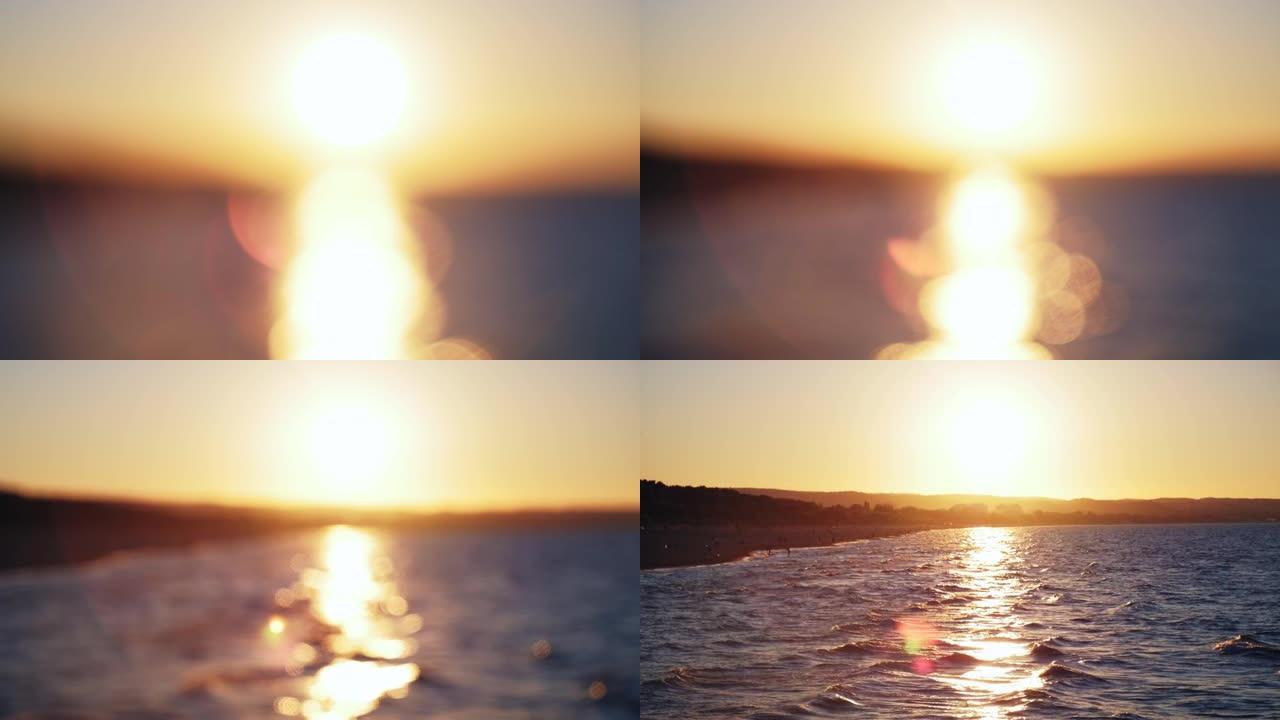 从码头焦点过渡处观察到的黄金时段日落时分有海浪和海滩的海景