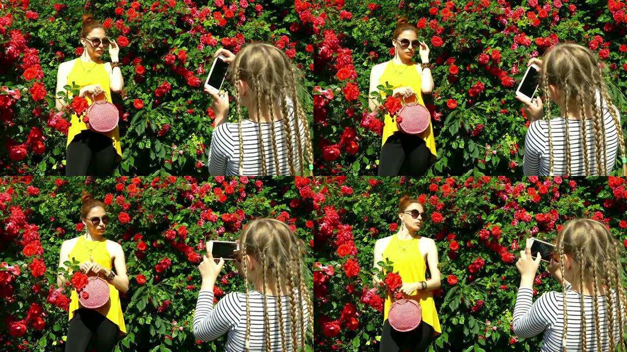 女孩在智能手机上拍摄玫瑰园中的美女