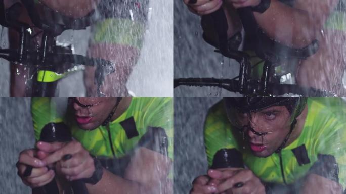 铁人三项运动员骑着专业的赛车自行车在黑暗中下雨进行激烈的锻炼。在天气恶劣的雨夜训练或比赛。