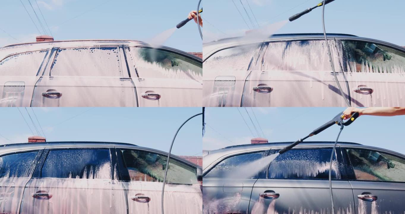 男子在外面用高压水射流洗车。汽车护理。汽车细节概念