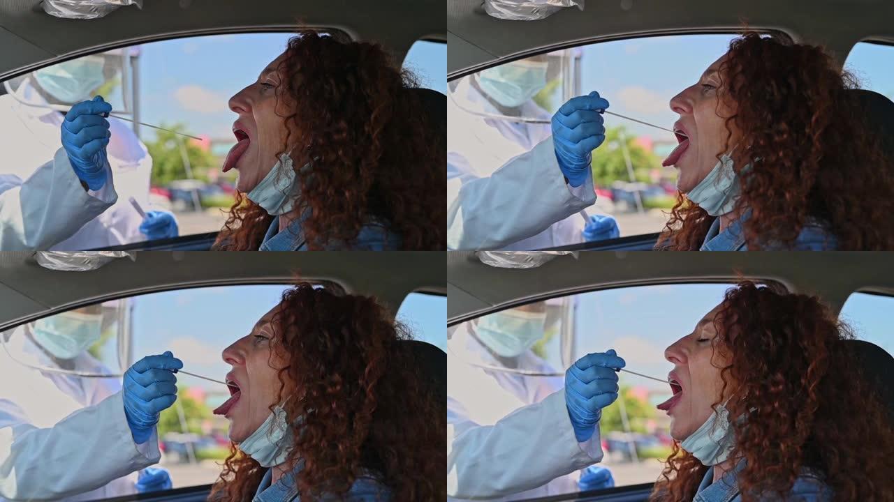 一名成熟女性在移动检测站拍摄喉咙拭子的4k视频片段