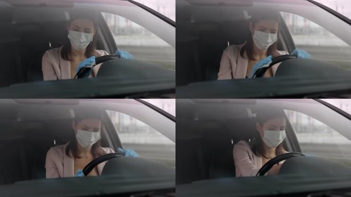 忧郁症妇女正在为汽车的方向盘消毒，担心感染