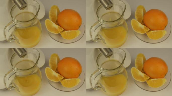 橙汁从榨汁机倒入玻璃壶中
