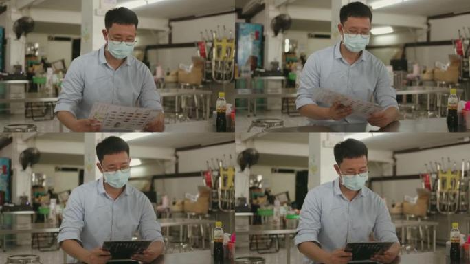 病毒流行期间，带防护面具的自由职业者翻转菜单在泰国当地快餐店选择餐饮-股票视频