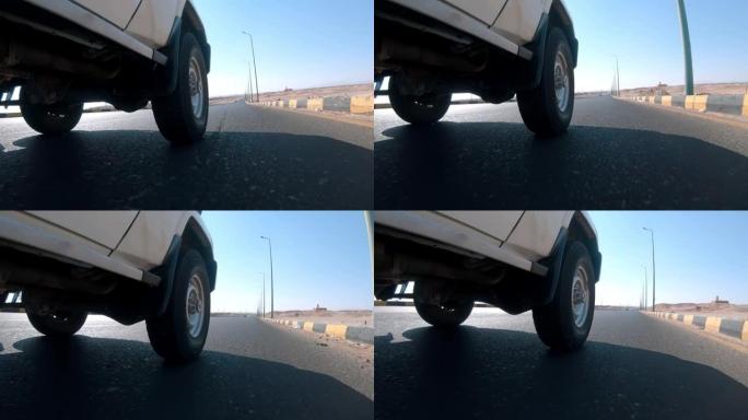 在沙漠中的道路上驾驶suv的低角度镜头